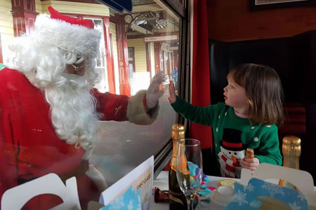 Photograph of Santa and girl on Santa Express train